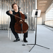 Musician using miniput music stand basic set while performing